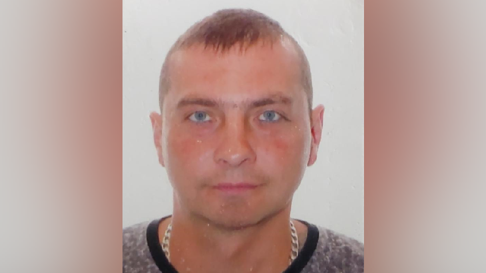 A photo of Gerard Trojanowski. He has cropped brunette hair and blue eyes.