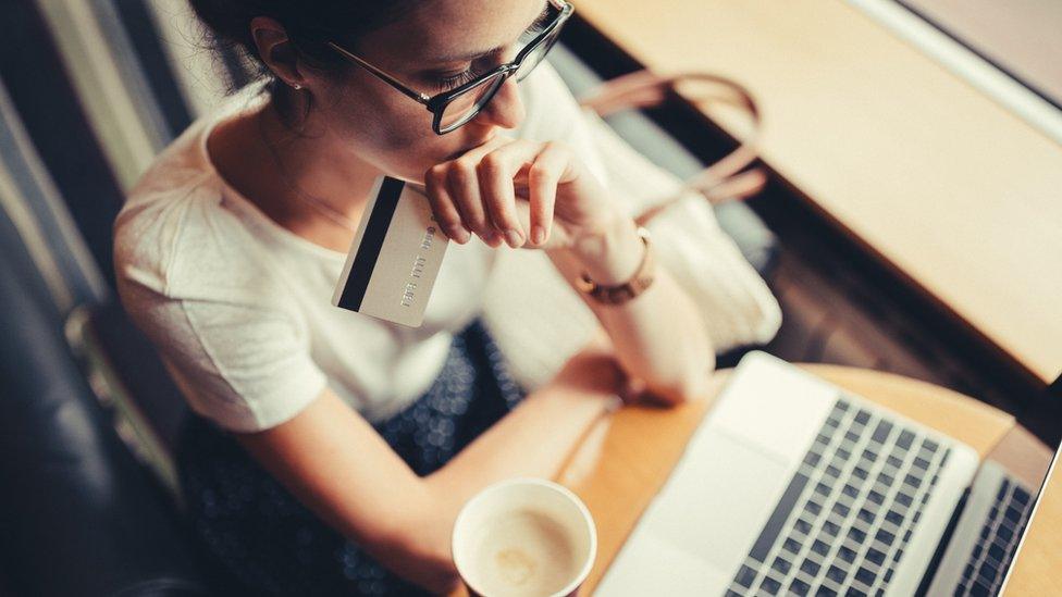 Woman using her credit card online