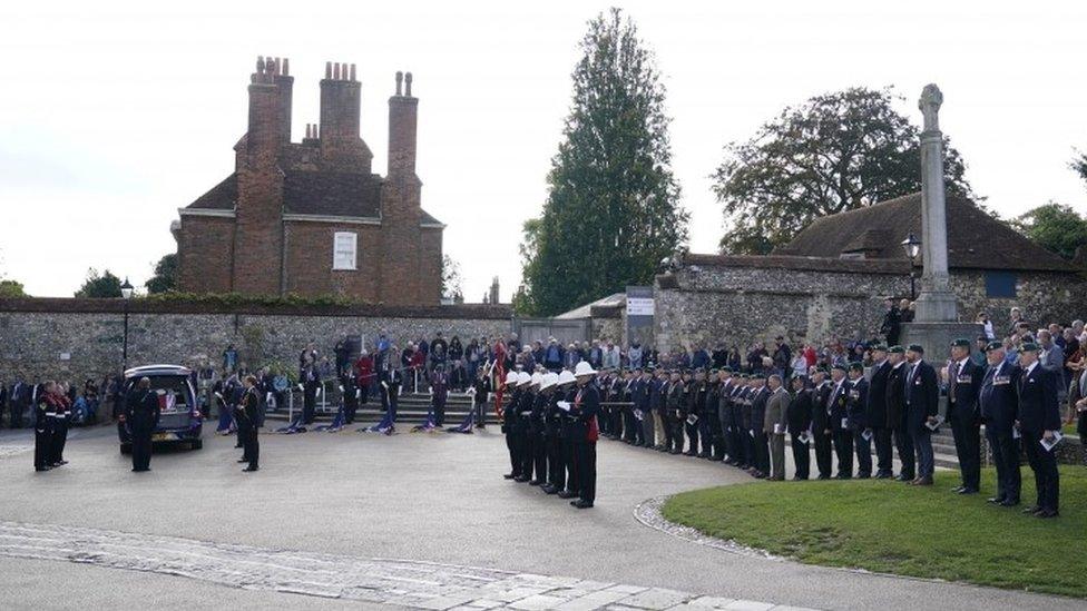 Pallbearers prepare to carry the coffin of Major General Matthew Holmes, the former head of the Royal Marines, into Winchester Cathedral