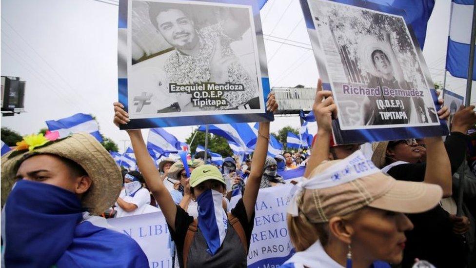 Demonstrators hold up pictures of students killed during the anti-government protests, while taking part in a march to demand the ouster of Nicaragua's President Daniel Ortega in Managua, Nicaragua, July 23, 2018.