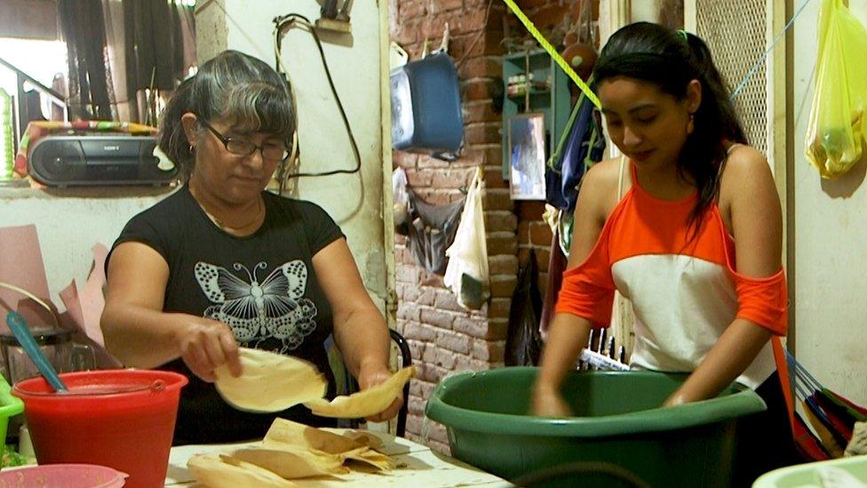 Laura Gómez (left) making tamales