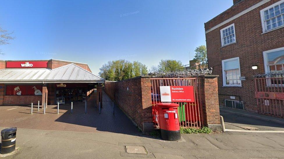 Narrow walkway bordered by a Wilko store and a postal sorting office