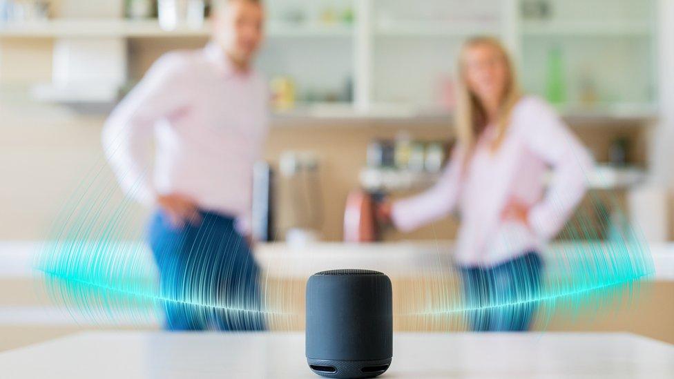 couple in kitchen with smart speaker