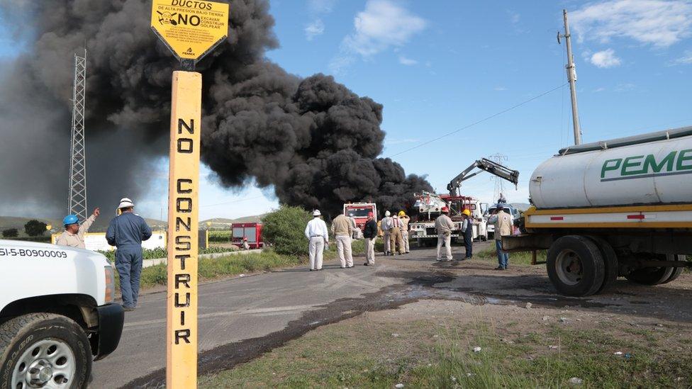 Mexican state-owned oil company Pemex and local firefighters work to control a fire believed to have started in the pipe due to fuel theft activity near the community of Cuesta Blanca, in the state of Puebla, Mexico, 4 July 2017