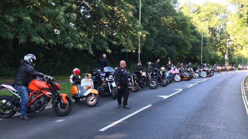 Motorcyclists line the route of the funeral procession