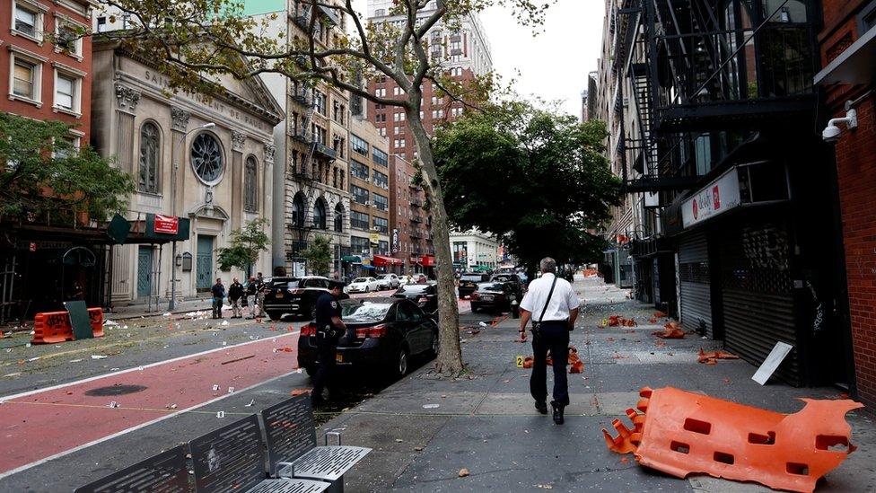 Police investigate at the site of an explosion that occurred on Saturday night on September 18, 2016 in the Chelsea neighborhood of New York City. An explosion in a construction dumpster that injured 29 people is being labeled an "intentional act". A second device, a pressure cooker, was found four blocks away that an early investigation found was likely also a bomb.