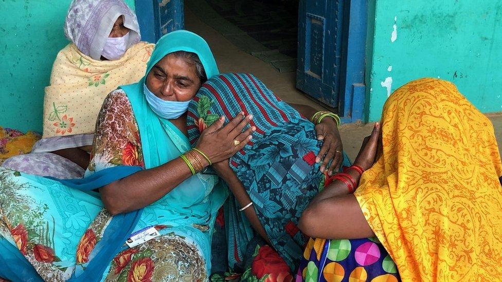 The victim's aunt consoles the 19-year-old's mother