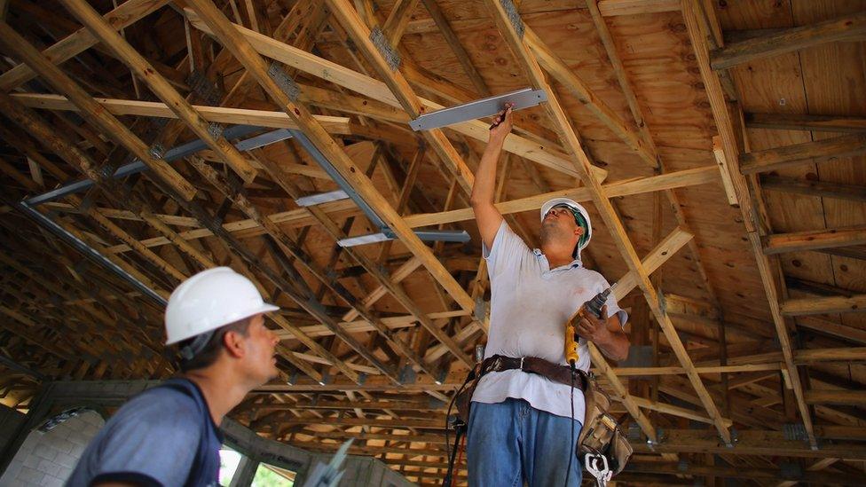 Construction workers, Louis Delgado (L) and Tony Rodriguez work on building a Toll Brothers Inc. home on September 26, 2012 in Boca Raton, Florida