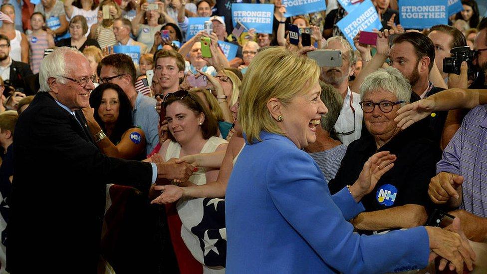 Bernie Sanders and Hillary Clinton shake hands after the Vermont senator endorses his former adversary.