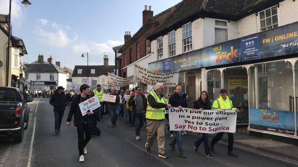 Matt Hancock and Lucy Frazer walking at front of protest against Sunnica solar farm