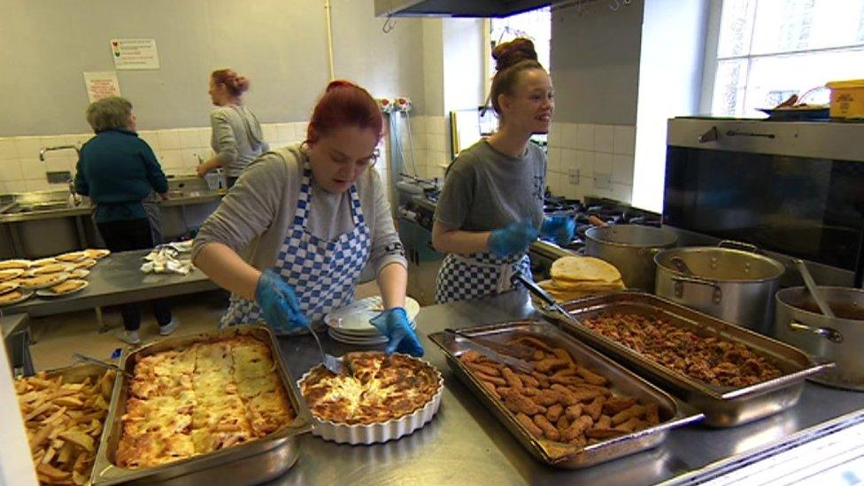 Staff at the Gathering Place handing out free meals