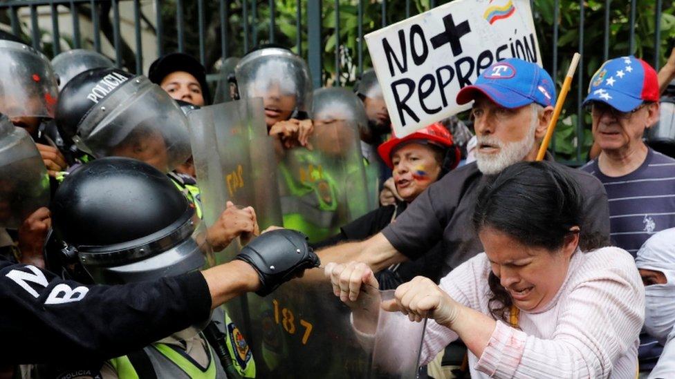 Demonstrators clash with riot police at "Grandparents March" in Caracas