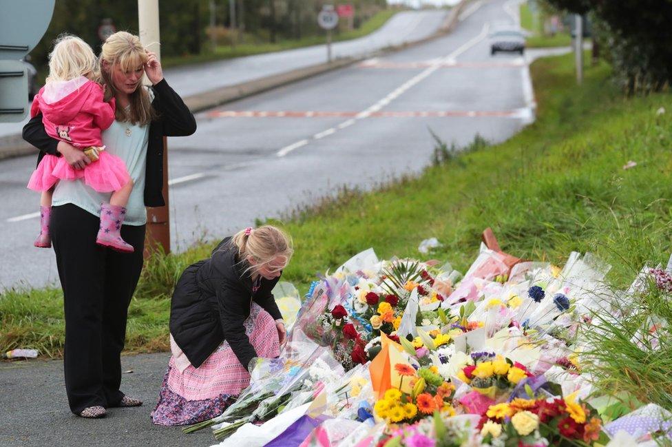 PC Phillip's widow Jen and his daughters leave flowers at the scene of his death