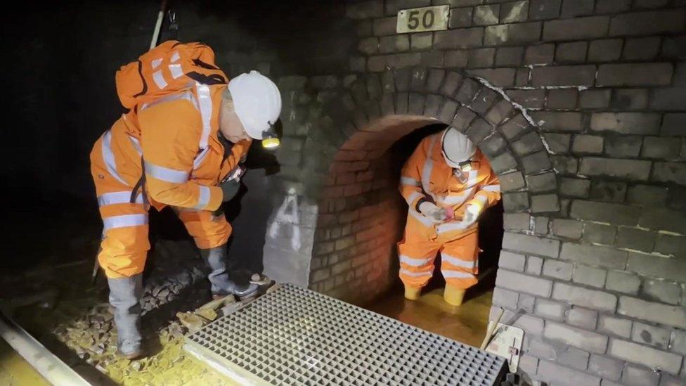 Engineers in railway tunnel