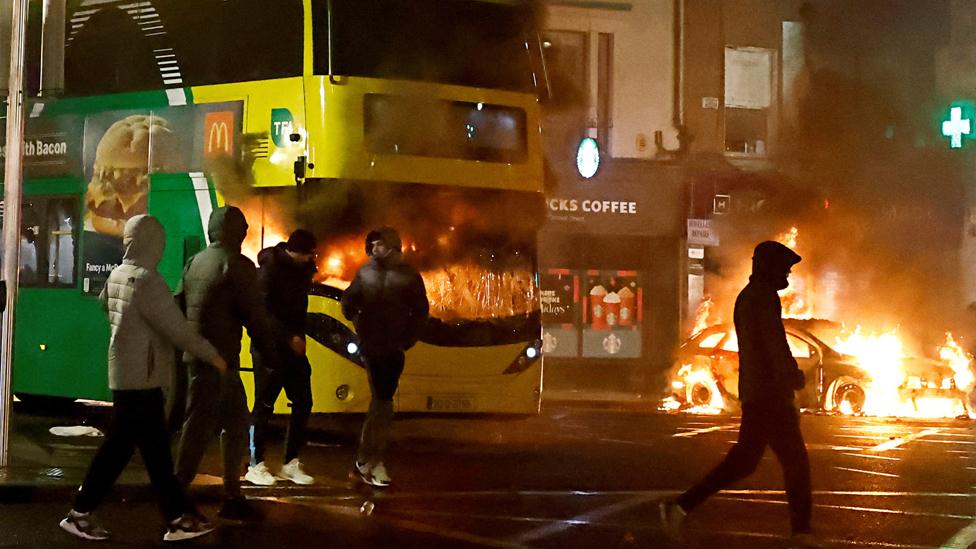 A bus burns during a demonstration in Dublin, Ireland, on 23 November 2023