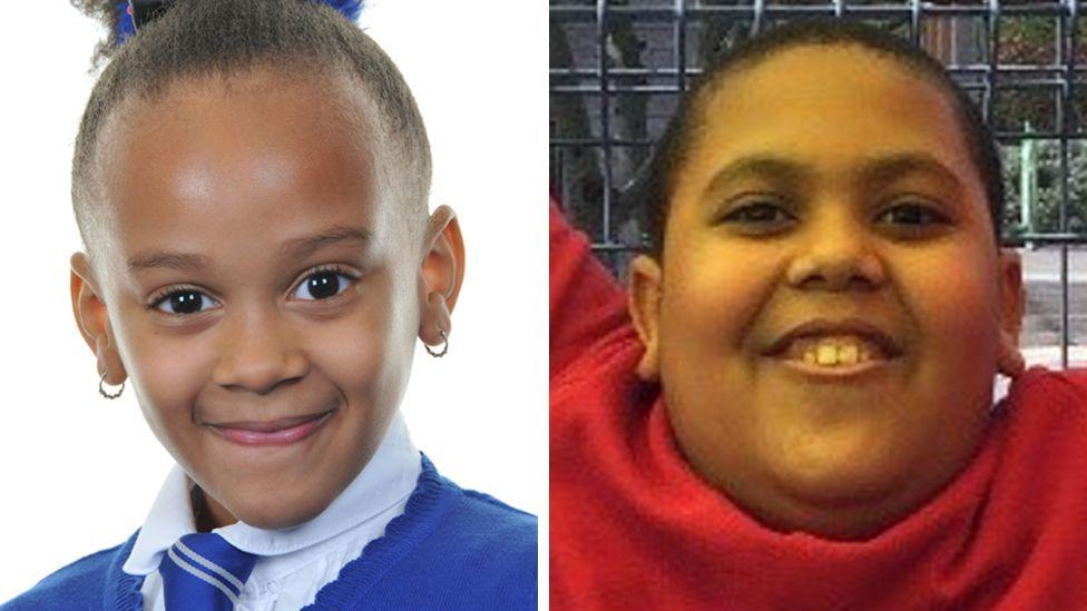 Elizabeth John is in the left image. She is wearing a white shift and blue jumper with a blue tie. She has earrings and her hair is tied back and she is smiling. and Ethan John. Ethan John is in the right image. He is wearing a red jumper and is looking up and smiling. He is outdoors and has a fence behind him.