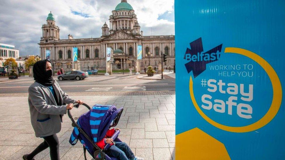 Woman pushing pram in Belfast