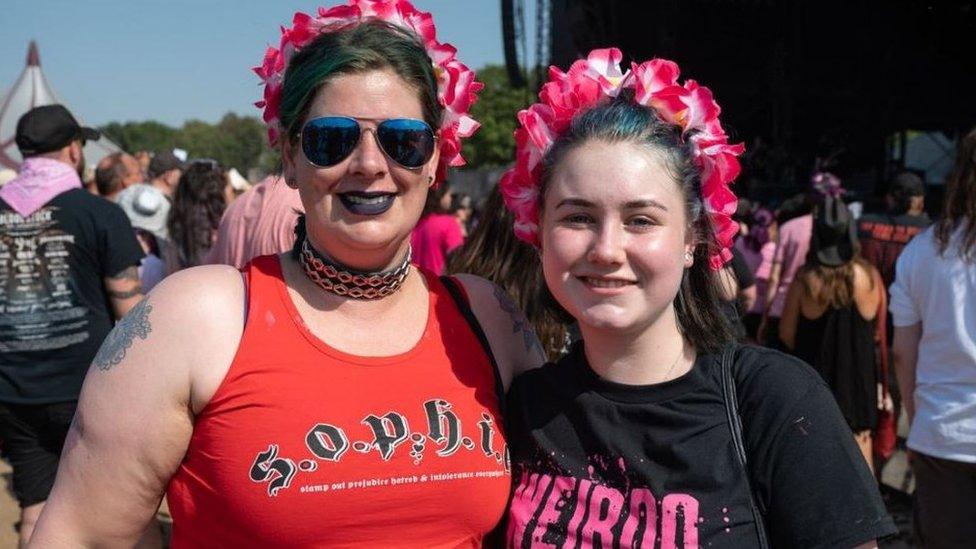 Two festivalgoers with pink headbands at the festival