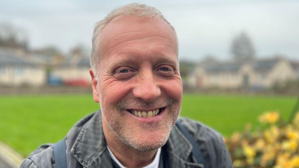 Head and shoulders shot of Dr Martin Purdy smiling in the village