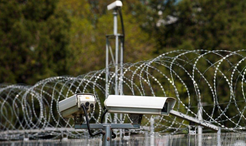 Barbed wire and security cameras at Hanslope Park