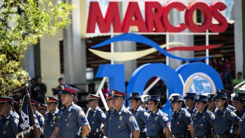 Policemen stand in formation during celebrations to mark his 100th birthday of late dictator Ferdinand Marcos in Batac, Ilocos Norte province, north of Manila on September 10, 2017.