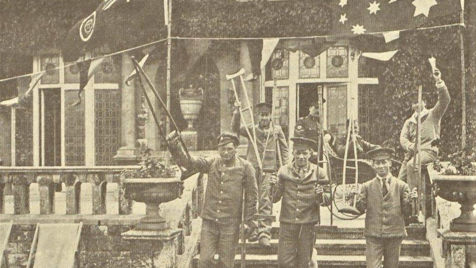 A black and white image showing injured Canadian soldiers holding their crutches in the air