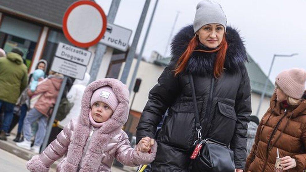 A family crossing the border into Poland from Ukraine