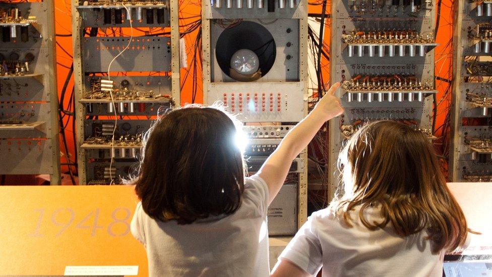 Children study a working replica of the machine