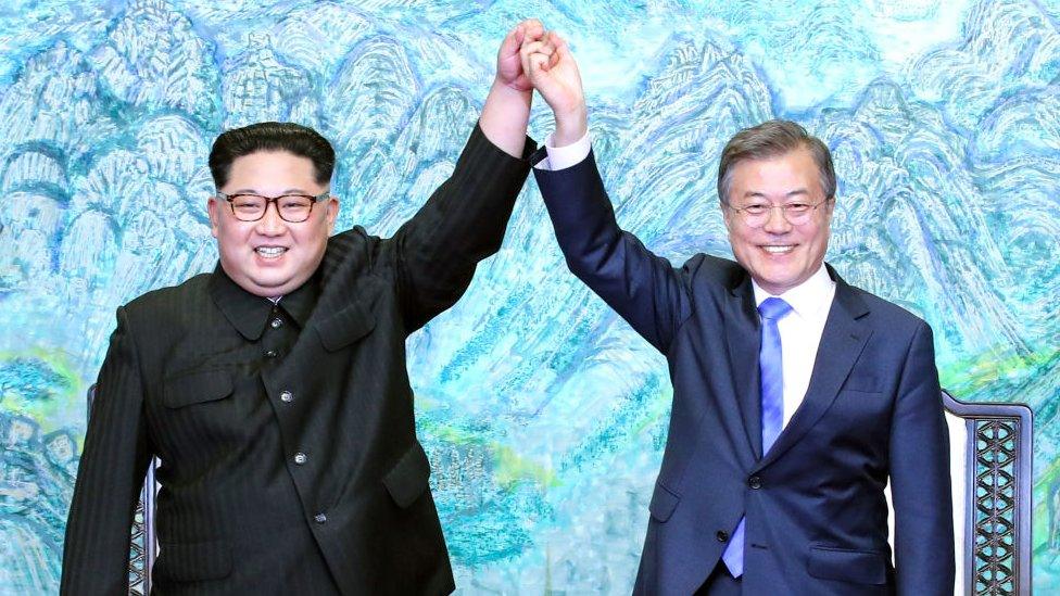 North Korean leader Kim Jong Un (L) and South Korean President Moon Jae-in (R) pose for photographs after signing the Panmunjom Declaration