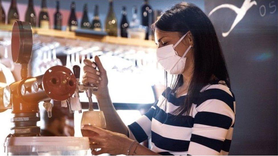 Barmaid pouring pint