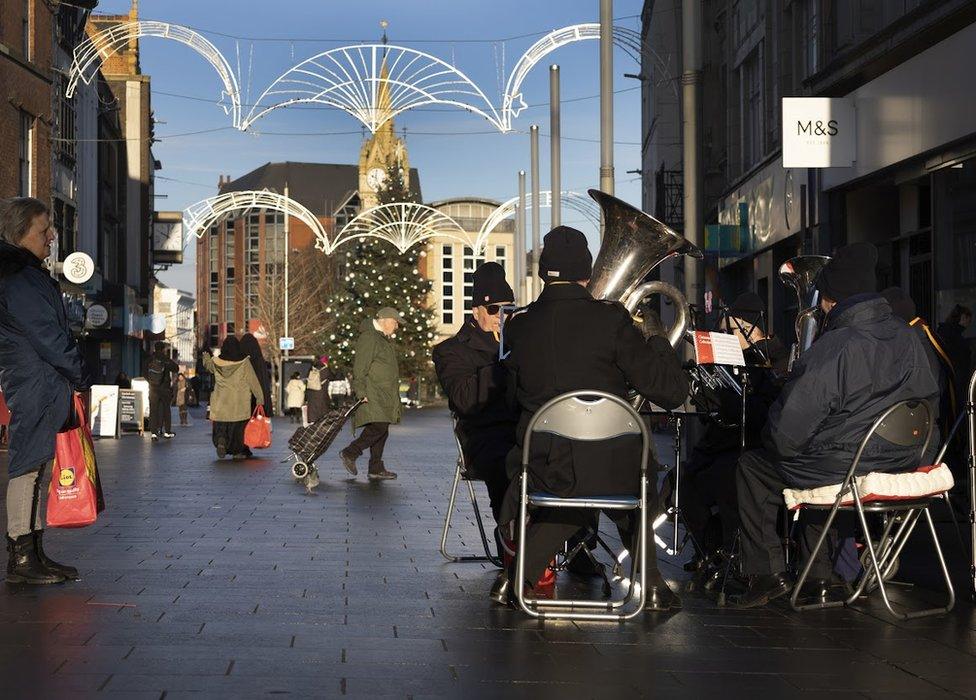 Brass ensemble plays in shopping street in Leicester