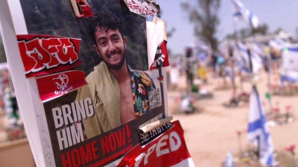 A poster calling for the release of Israeli hostage Hersh Goldberg-Polin at the site of the Nova festival, in southern Israel