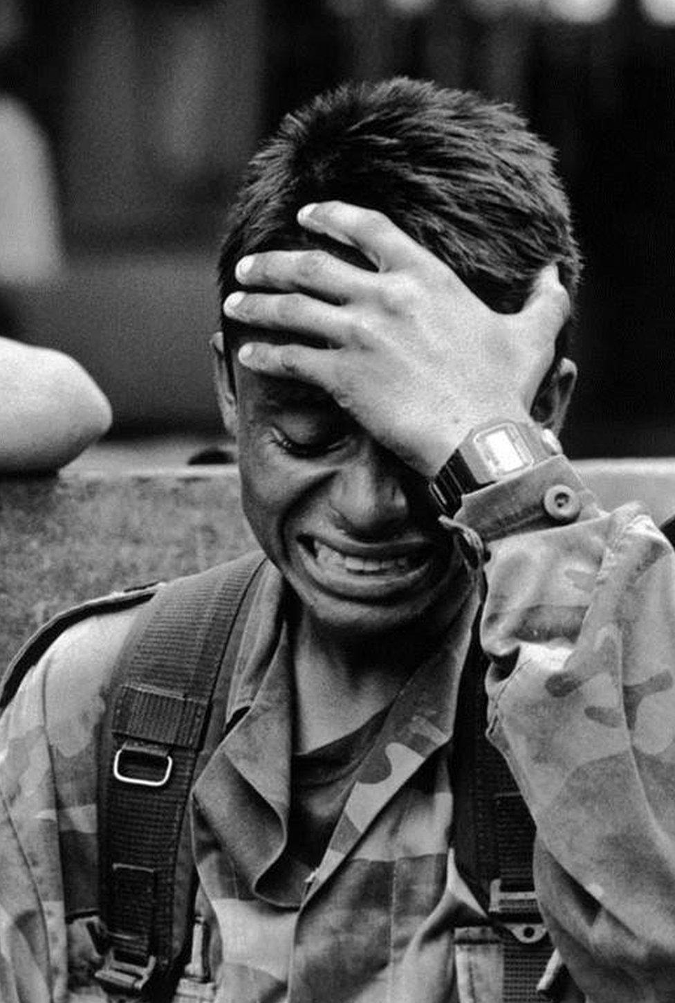 Soldier crying after guerrillas killed his 13-year-old sister