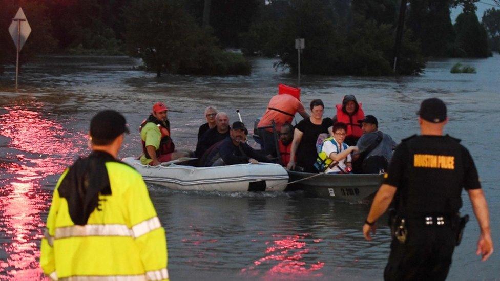 Victims are rescued by boat in Houston