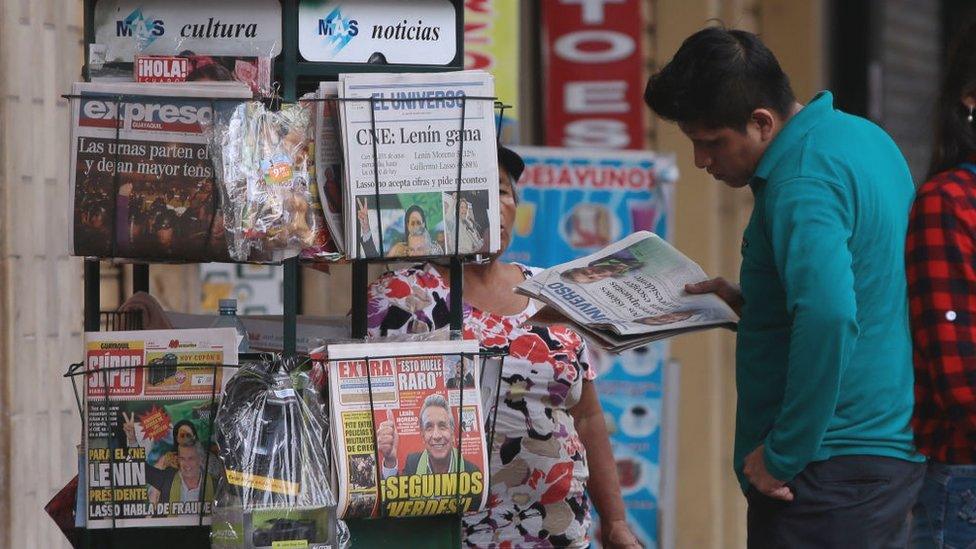 Man reads papers announcing Lenin Moreno's victory in the 2017 presidential elections