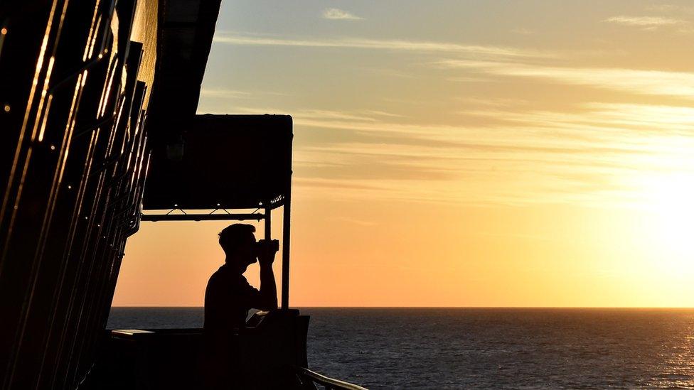 A sailor of the German navy frigate ship Werra looks at the sea in the southern Mediterranean