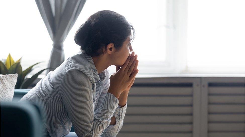 Generic image of a woman looking out of a window