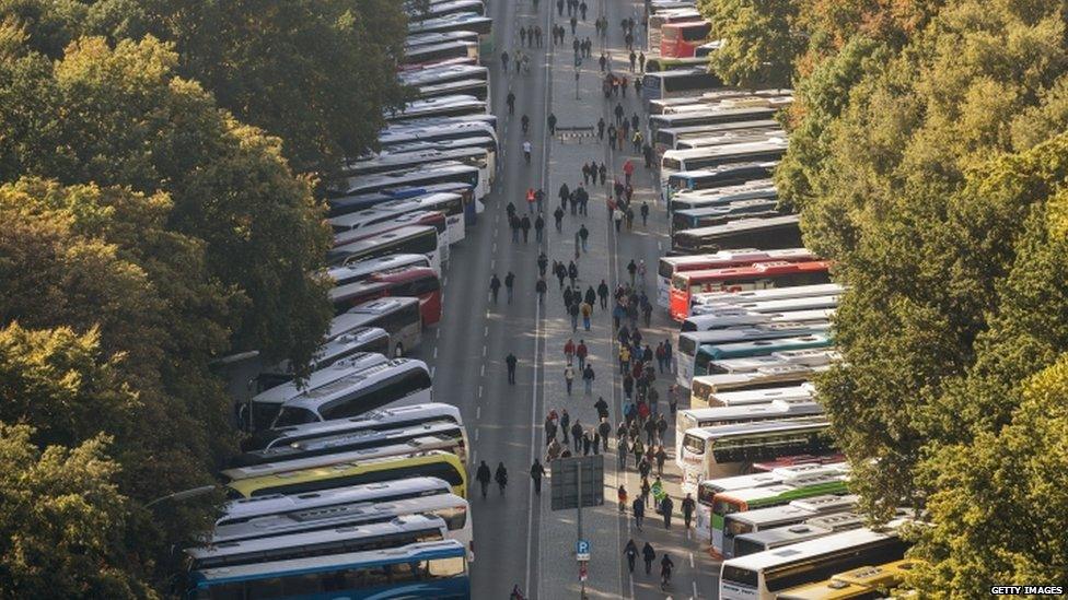 Buses wait for protesters at a rally against an EU-US trade deal in Berlin