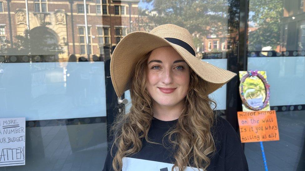 Woman with long hair wearing floppy hat