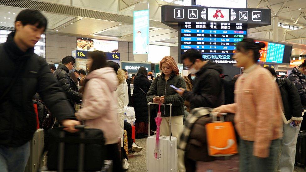 Travellers wait for their trains at Shanghai Hongqiao railway station, during the Spring Festival travel rush