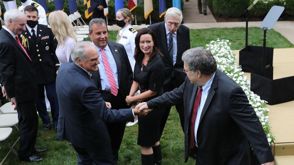 Attorney General Bill Barr greets guests including Chris Christie (wearing the pink tie)