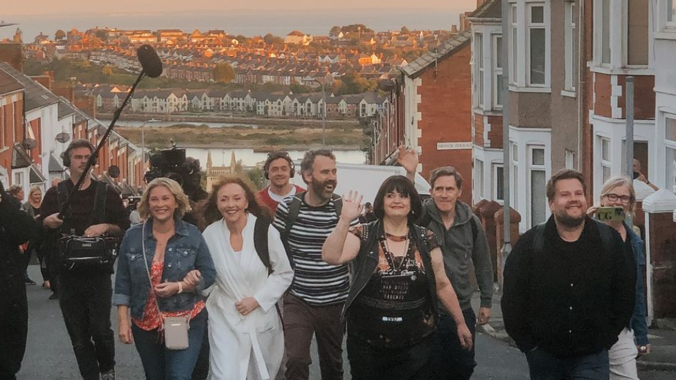 Joanna Page, Melanie Walters, Robert Wilfort, Ruth Jones, rob Brydon and James Corden on Trinity Street with sunset behind