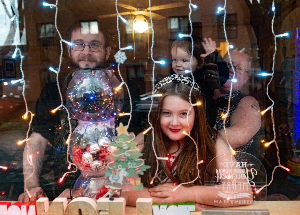 The Dawson family through the window of their home in Nottingham