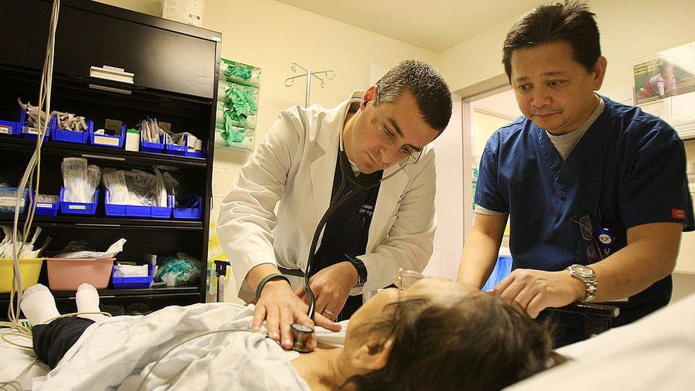 A doctor and a nurse treat a woman in Panorama City, California.