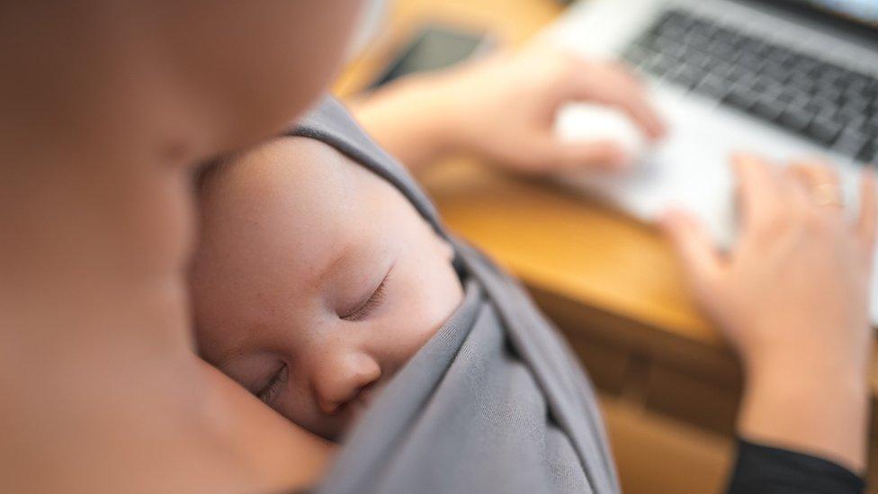 Mother working with baby