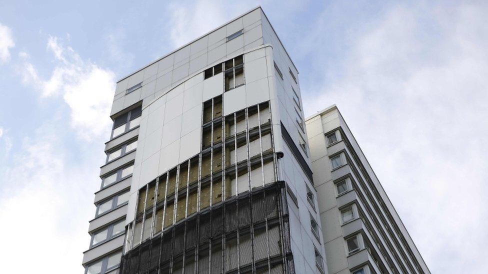 A tower in Islington missing a portion of its cladding