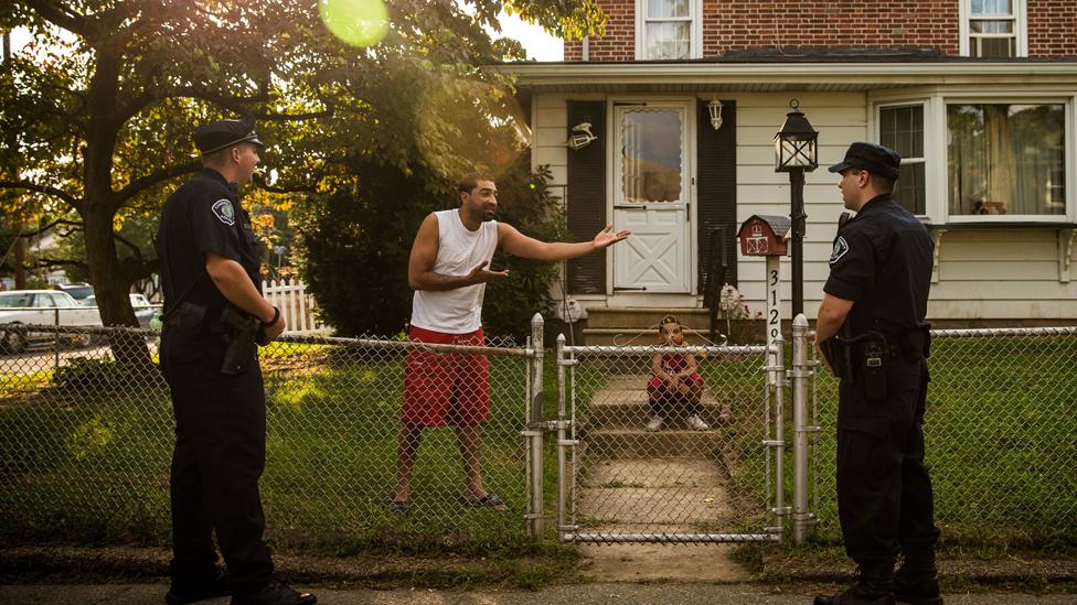 Wilfredo Ortiz speaks to foot patrol officers of the Camden County Police Department (CCPD) on August 20, 2013 in the Fairview neighbourhood of Camden, New Jersey.