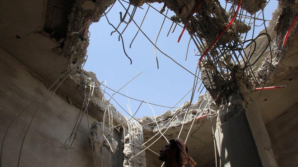 Man inspects building damaged in reported Saudi-led coalition air strike in Saada province, Yemen (10 September 2016)