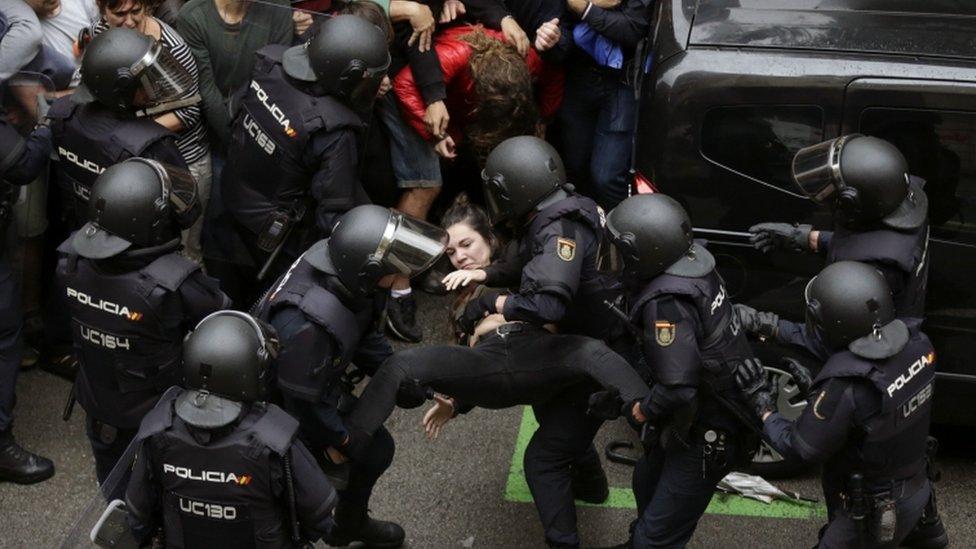 police arresting woman during Catalan referendum