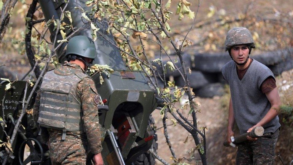 A picture provided by the Armenian Defence Ministry Press Office via PAN Photo shows Armenian soldiers fire during military combat with the Azerbaijani army in the Nagorno-Karabakh Republic